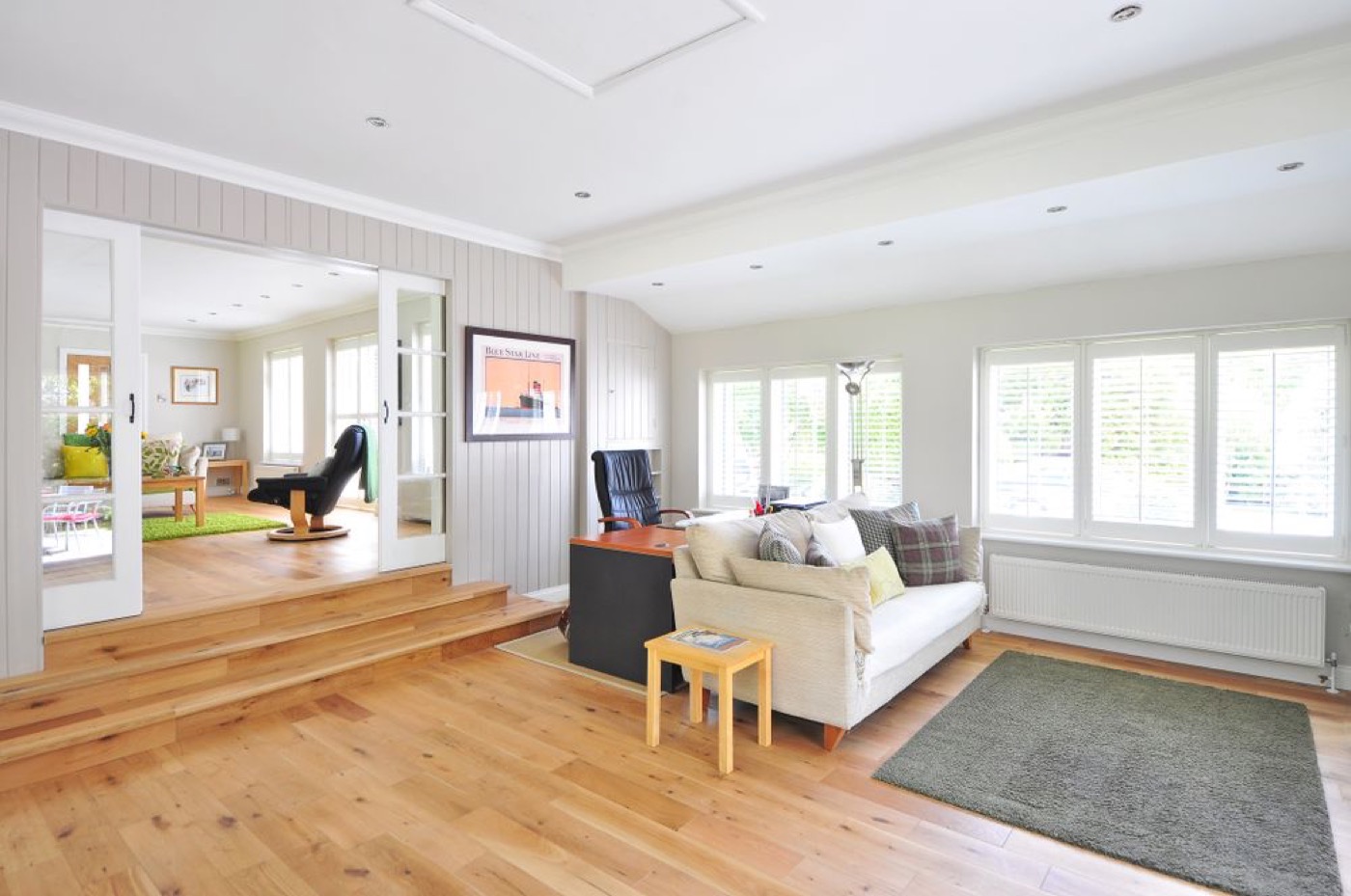 An open living space with hardwood floors and wide windows.