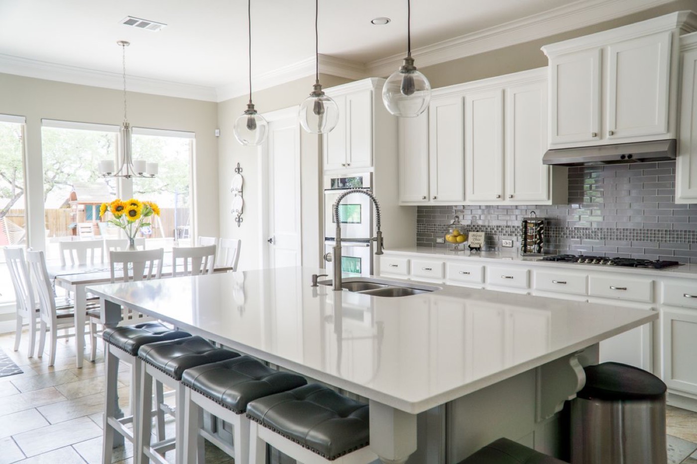 A bright kitchen with white cabinets and a large island.